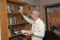 Chief Master Sgt. ret. Wallace Curtis, donates books to the Joint Base San Antonio-Randolph library Nov. 18, 2015.  The library provides opportunities and resources for continual improvement of professional development and community support. (U.S. Air Force photo by Joel Martinez/Released)
