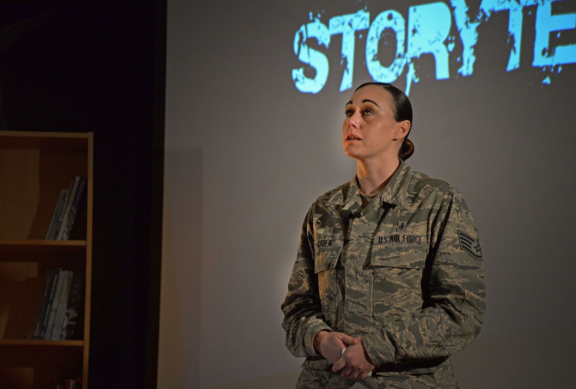 U.S. Air Force Destini Yaden, 27th Special Operations Medical Operations Squadron Mental Health element, fights back tears while sharing her story with a crowded room during the second Storytellers Nov. 19, 2015, at Cannon Air Force Base, N.M. Yaden shared a heart wrenching tale of domestic violence. (U.S. Air Force photo/Staff Sgt. Alexx Pons) 