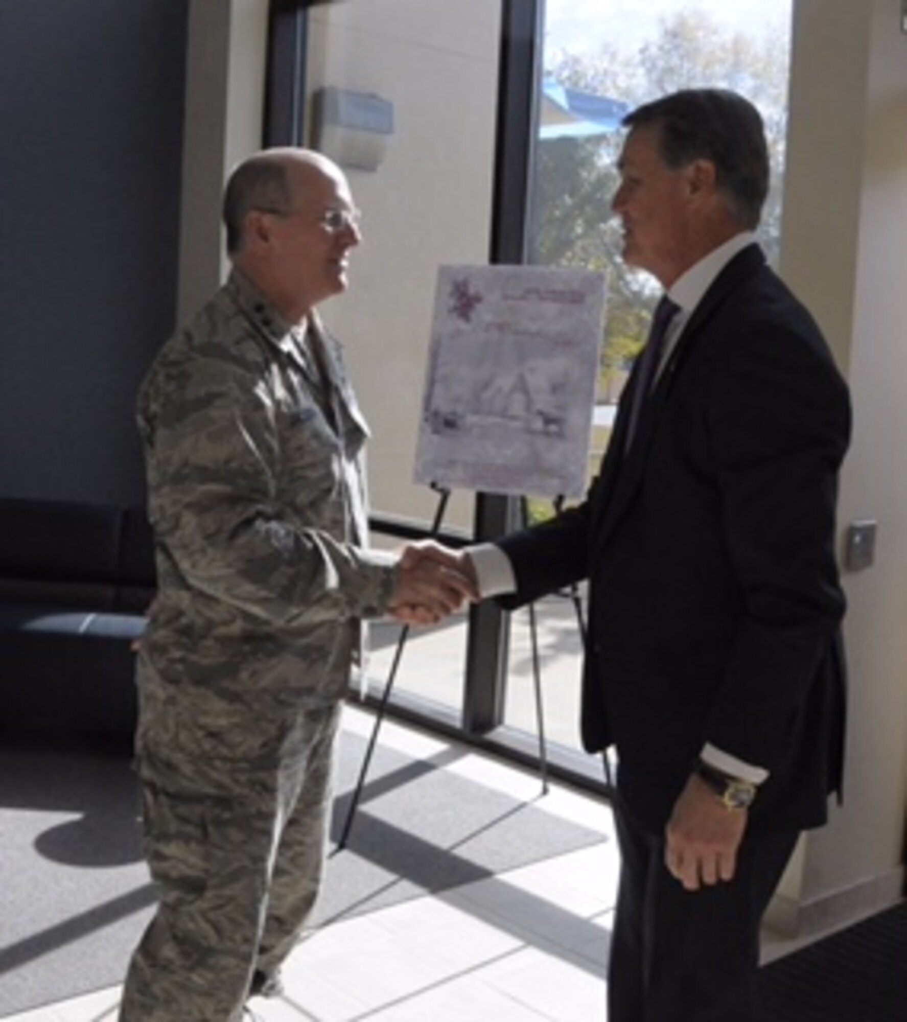 Lt. Gen. James Jackson, chief of Air Force Reserve, Headquarters U.S. Air Force, Washington, D.C., and Air Force Reserve Command commander, welcomes U.S. Senator David Perdue, (R) Georgia, to HQ AFRC, Robins Air Force Base, Georgia, Nov. 24, 2015. (U.S. Air Force photo by Robert Helton/RELEASED)