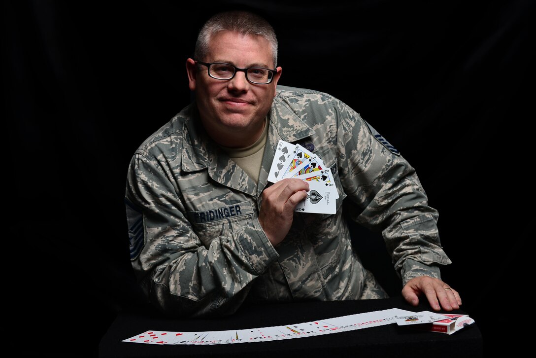 U.S. Air Force Master Sgt. Scott Fridinger, additional duty first sergeant assigned to the Air Combat Command Communications Support Squadron, displays a royal flush at Langley Air Force Base, Va., Oct. 21, 2015. Fridinger uses magic to build rapport with his airmen and enhance morale. U.S. Air Force photo by Senior Airman Aubrey White