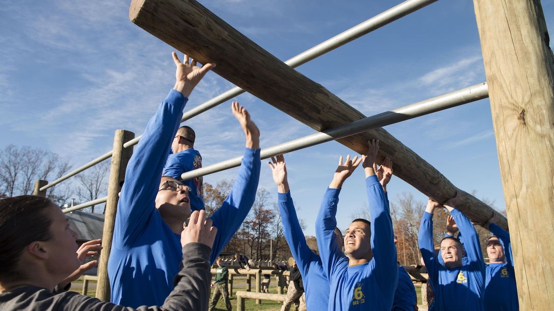 Candidates in Officer Candidate School lift a log through an obstacle during an exercise at Marine Corps Base Quantico, Virginia,. Nov. 20, 2015. Class OCC-220 graduated and were commissioned as second lieutenants after 10 weeks of physically and mentally demanding training. (U.S. Marine Corps photo by Lance Cpl. Erasmo Cortez III)