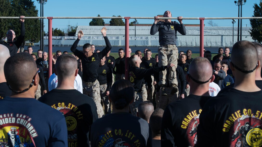 Candidates in Officer Candidate School execute pull-ups during an exercise at Marine Corps Base Quantico, Virginia, Nov. 20, 2015. The candidates of Class 0CC-220 graduated and were commissioned as second lieutenants during the 75th anniversary of OCS. (U.S. Marine Corps photo by Sgt. Eric Keenan)
