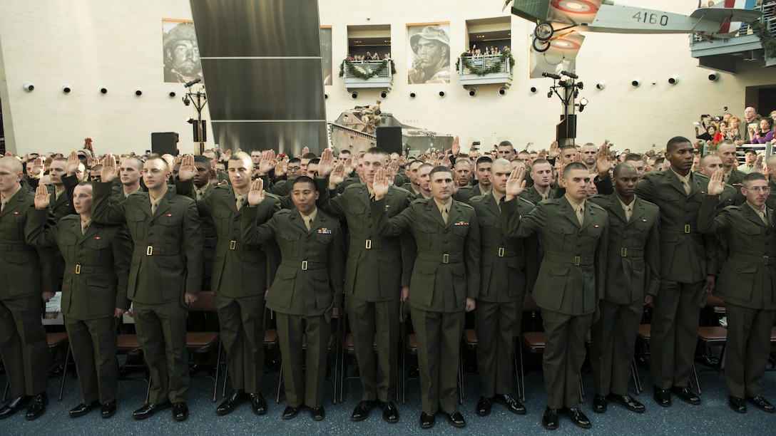 Candidates of Class OCC-220 in Officer Candidate School take their oaths of enlistment during their graduation ceremony at Marine Corps Base Quantico, Virginia. Nov. 24, 2015. OCS celebrated  the 75 years of Marine officer training on Marine Corps Base Quantico. (U.S. Marine Corps photo by Lance Cpl. Erasmo Cortez III )