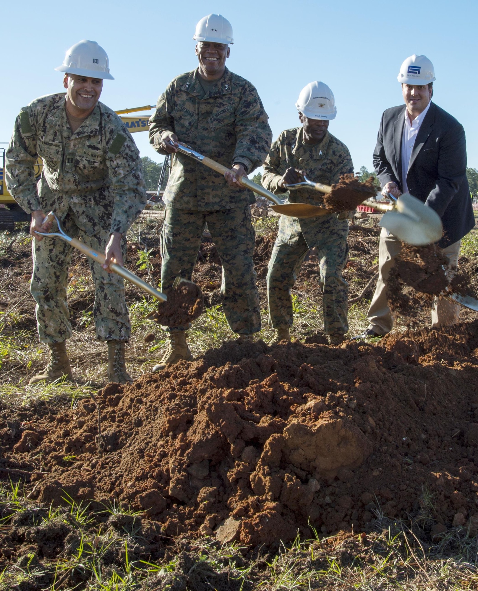 Officials move shovels full of dirt for construction of the new, nearly 59,000-square-foot Weapons Storage and Inspection Facility during a groundbreaking ceremony aboard Marine Corps Logistics Base Albany, Nov. 23. From left: Navy Lt. Jose Centenorosado, director, Facilities Engineering and Acquisition Division, MCLB Albany; Maj. Gen. Craig C. Crenshaw, (second from left) commanding general, Marine Corps Logistics Command; Col. James C. Carroll III (third from left), commanding officer, MCLB Albany; and Kevin Murphy, vice president, Gulf-Hernandez Joint Venture.