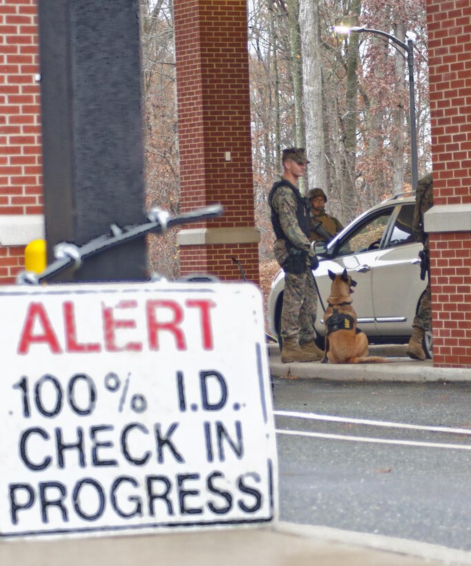 Marines provide security at the back gate of Marine Corps Base Quantico. The base will soon implement new system called RAPIDGate to improve the ability of military police officers to verify who is coming aboard the installation.