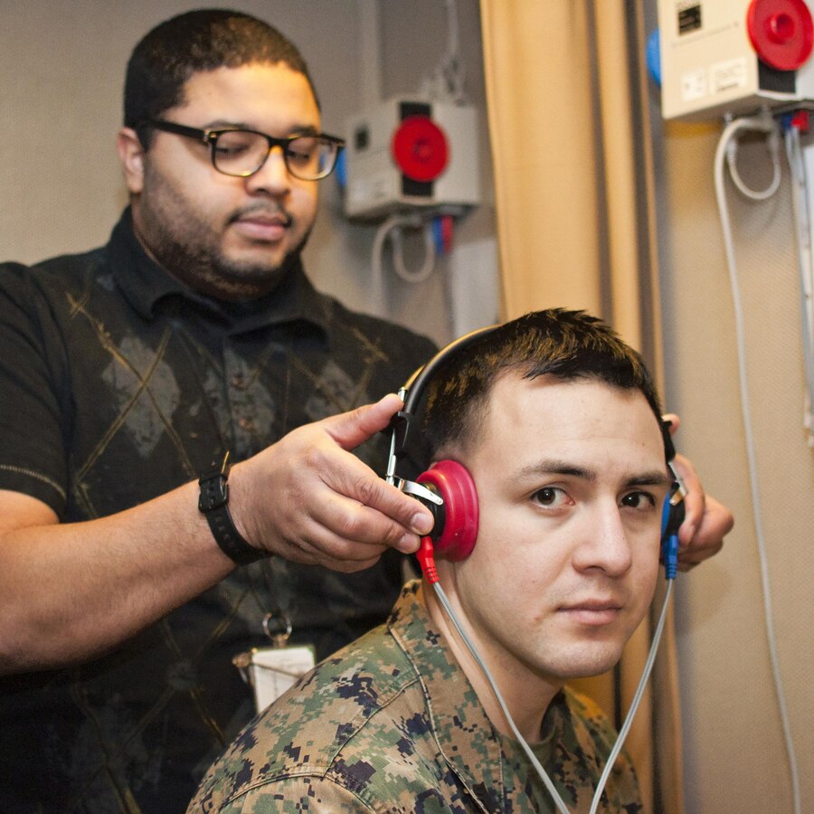 Sgt. Oscar Portillo, Marine Corps security guard, visits the hearing test booth operated by Mike Rodriguez, Naval Health Clinic Quantico audiology technician, Nov. 20, during his post-deployment health assessment. Portillo recently redeployed from Rabat, Moracco.