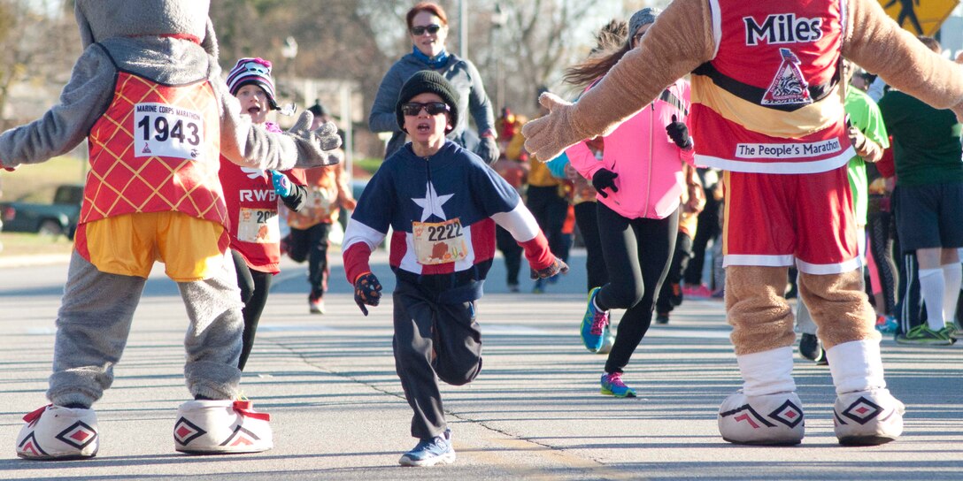 A child completes the one-mile fun run at the Turkey Trot 10K.