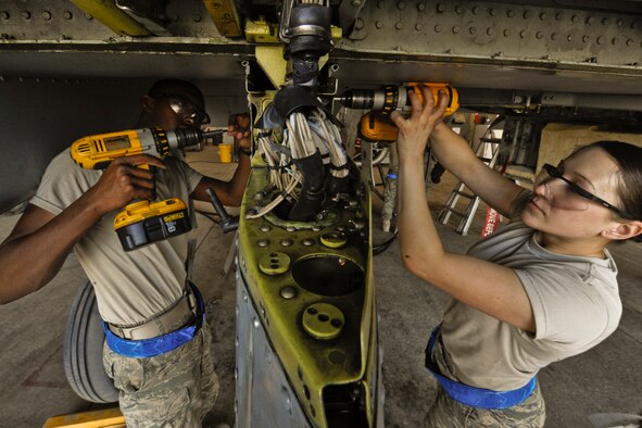 U.S. Air Force Airman Derrick Coakley (left) and Senior Airman Sophia Ramallo perform maintenance on an A-10C Thunderbolt II aircraft at Kandahar Air Field, Afghanistan, on Dec. 27, 2009.  Coakley and Ramallo are assigned to the 451st Expeditionary Maintenance Squadron.  DoD photo by Tech. Sgt. Efren Lopez, U.S. Air Force.  (Released)