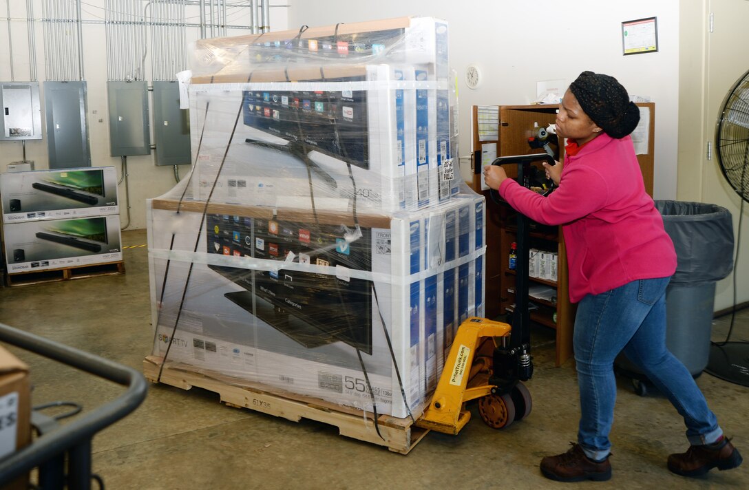 Kaitlyn Baggs, store worker, moves a pallet of merchandise in preparation for the Marine Corps Exchange Black Friday Doorbusters sale to be held Nov. 27 at Marine Corps Logistics Base Albany.