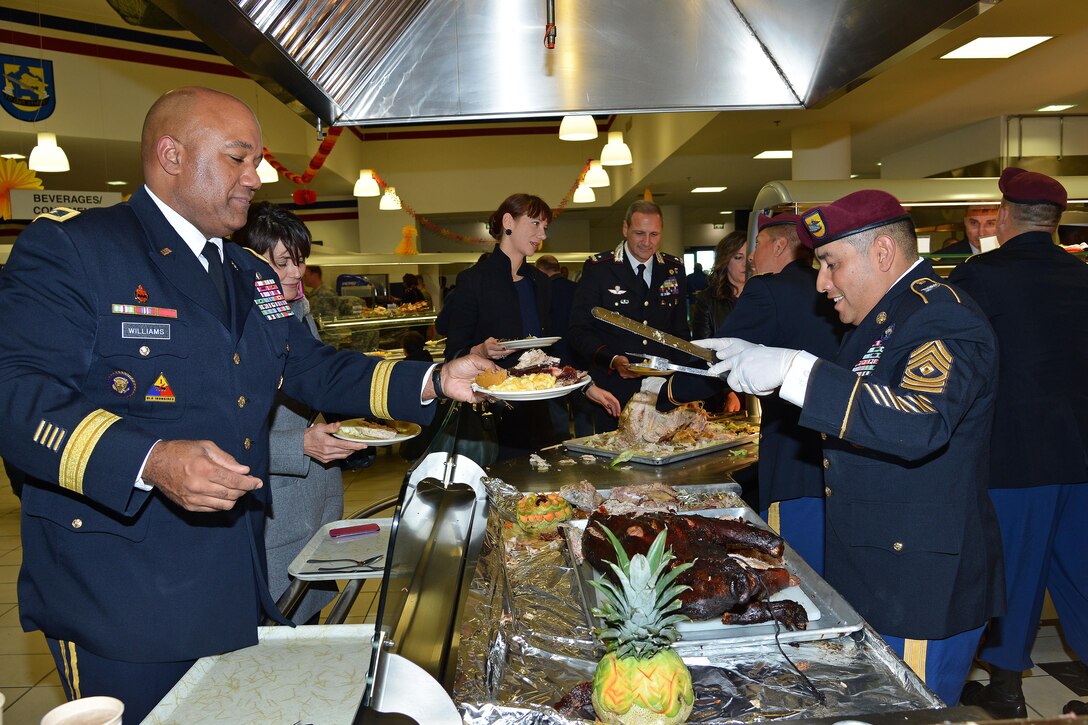 U.S. Army Sgt. 1st Class Norberto Badillo, right, serves a Thanksgiving lunch to U.S. Army Maj. Gen. Darryl A. Williams, commander of U.S. Army Africa, during a celebration in Vicenza, Italy, Nov. 24, 2015. Badillo is a paratrooper assigned to the 173rd Brigade Support Battalion, 173rd Airborne Brigade. U.S. Army photo by Davide Dalla Massara