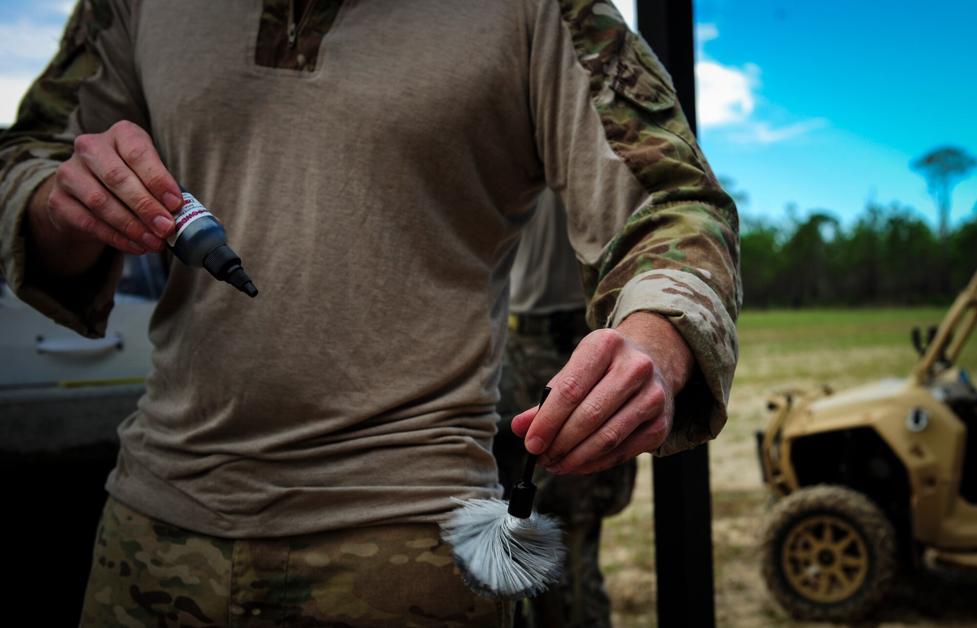 Tech. Sgt. Richard Peterson, an explosive ordnance disposal craftsman with the 1st Special Operations Civil Engineer Squadron, spins a finger print brush to remove excess dust at Hurlburt Field, Fla., Nov. 19, 2015. Evidence collected from an improvised explosive device allows EOD technicians to aid in finding the bomb maker. (U.S. Air Force photo by Senior Airman Meagan Schutter)