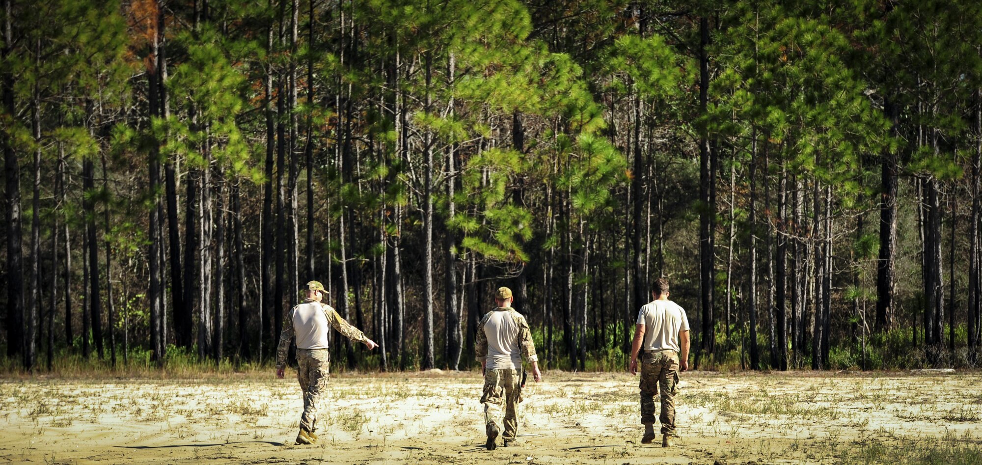 Explosive ordnance disposal Airmen with the 1st Special Operations Civil Engineer Squadron scan the ground for debris during post-blast analysis training at Hurlburt Field, Fla., Nov. 19, 2015. A Post-blast analysis takes place when an improvised explosive device detonates and EOD Airmen arrive on scene to determine what happened. (U.S. Air Force photo by Senior Airman Meagan Schutter)