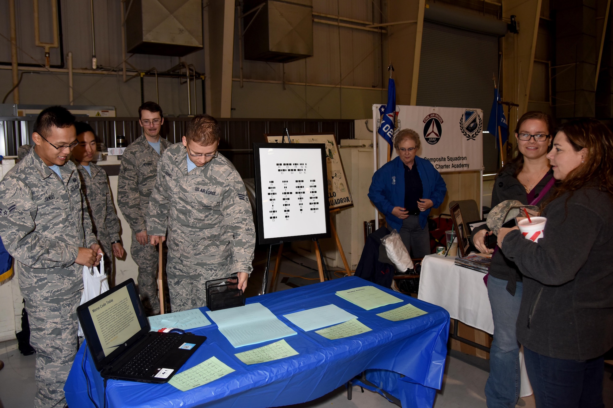 316th Training Squadron students talk about Morse code during the 7th Annual Goodfellow Community Appreciation Day at the Louis F. Garland Department of Defense Fire Academy on Goodfellow Air Force Base, Texas, Nov. 21, 2015. Students also provided foreign language translations and competed in a drill competition. (U.S. Air Force photo by Senior Airman Joshua Edwards/Released)
