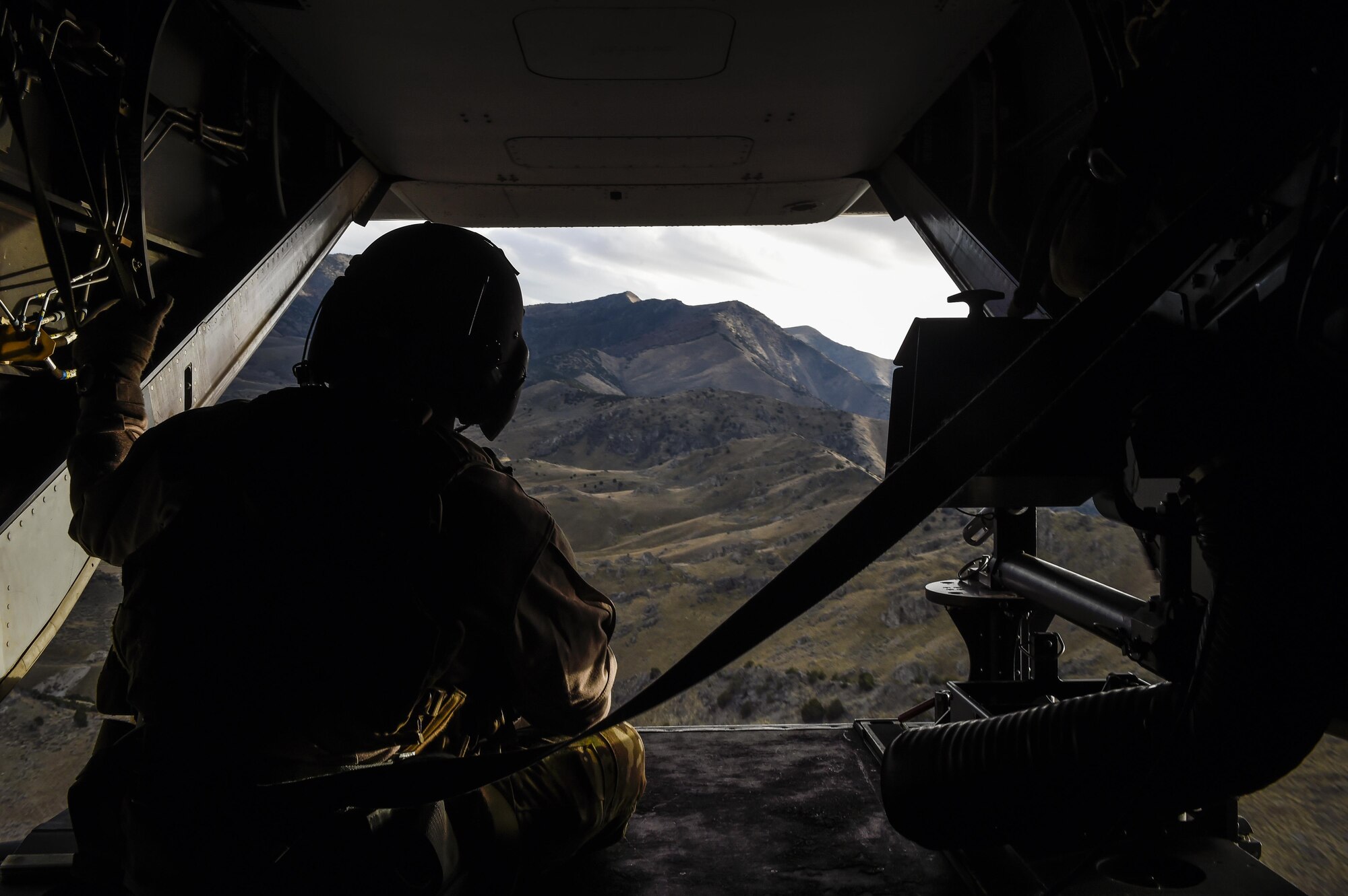 Staff Sgt. Michael Rossi, a special missions aviator with the 8th Special Operations Squadron, scans for potential hazards during a low-level training flight aboard a CV-22 Osprey at Hill Air Force Base, Utah, Nov. 4, 2015. Ultimate Archer was a task force exercise that put Air Commandos in an unfamiliar environment to practice deployed operations. The six-day exercise gave Hurlburt Airmen a chance to work with units outside of the 1st Special Operations Wing including the 388th Fighter Wing and the 19th Special Operations Group. (U.S. Air Force photo by Airman Kai White)
