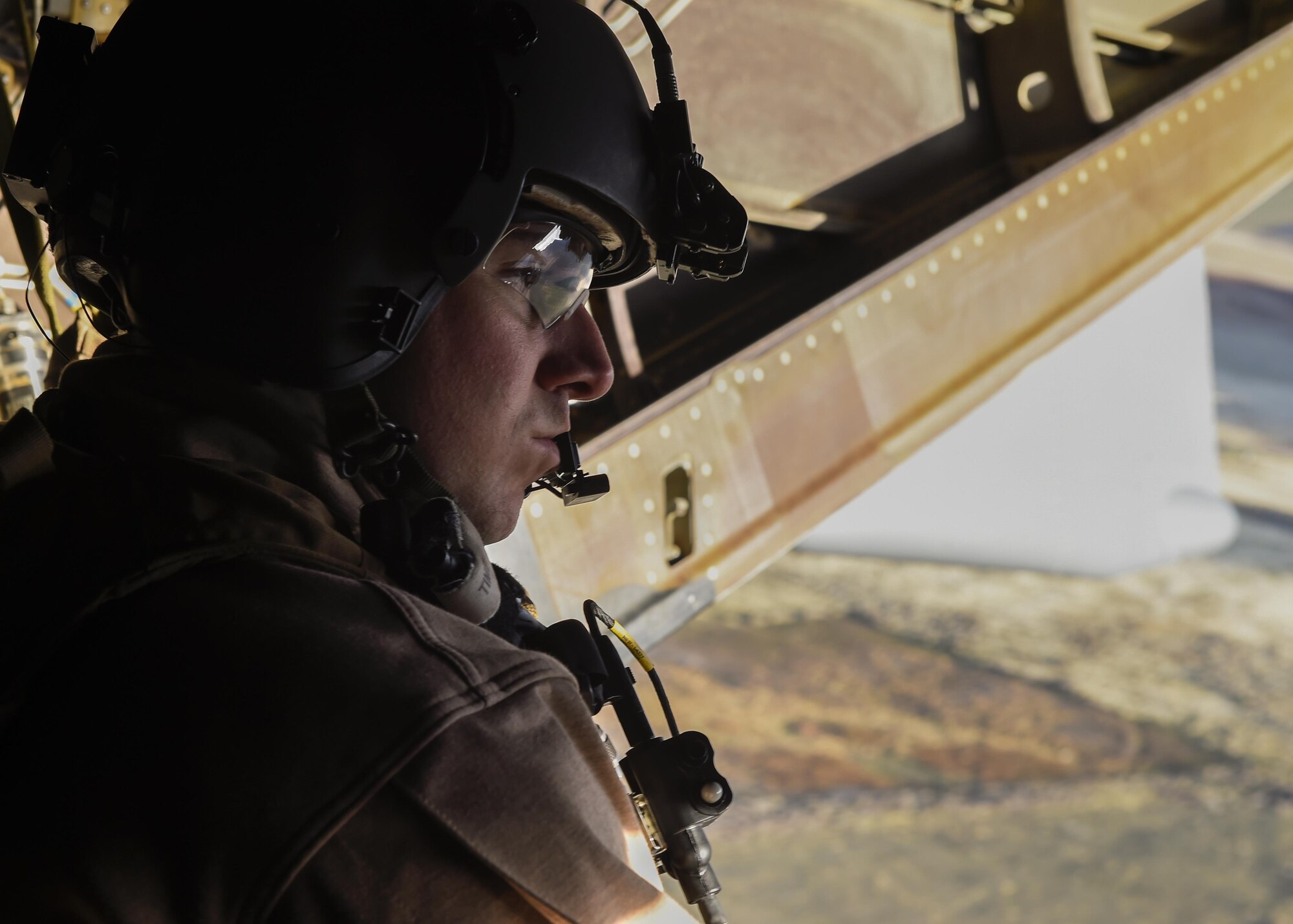 Staff Sgt. Michael Rossi, a special missions aviator with the 8th Special Operations Squadron, scans for potential hazards during a low-level training flight aboard a CV-22 Osprey at Hill Air Force Base, Utah, Nov. 4, 2015. Ultimate Archer was a task force exercise that put Air Commandos in an unfamiliar environment to practice deployed operations. The six-day exercise gave Hurlburt Airmen a chance to work with units outside of the 1st Special Operations Wing including the 388th Fighter Wing and the 19th Special Operations Group. (U.S. Air Force photo by Airman Kai White)
