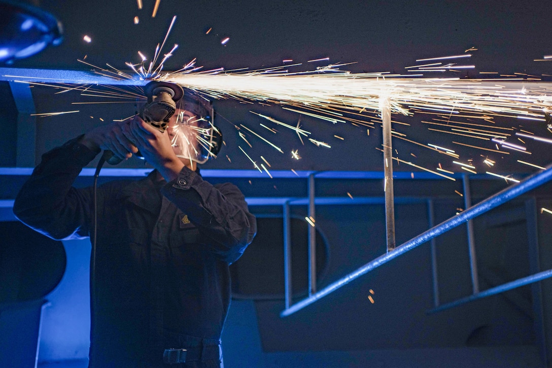 U.S. Navy Seaman Drew Jessup grinds metal from a beam aboard the aircraft carrier USS Dwight D. Eisenhower, on the Atlantic Ocean, Nov. 24, 2015. The Dwight D. Eisenhower, along with embarked Carrier Air Wing 3, is underway conducting training and evaluation as part of the basic phase of the Optimized Fleet Response Plan. U.S. Navy photo by Seaman Apprentice Casey S. Trietsch