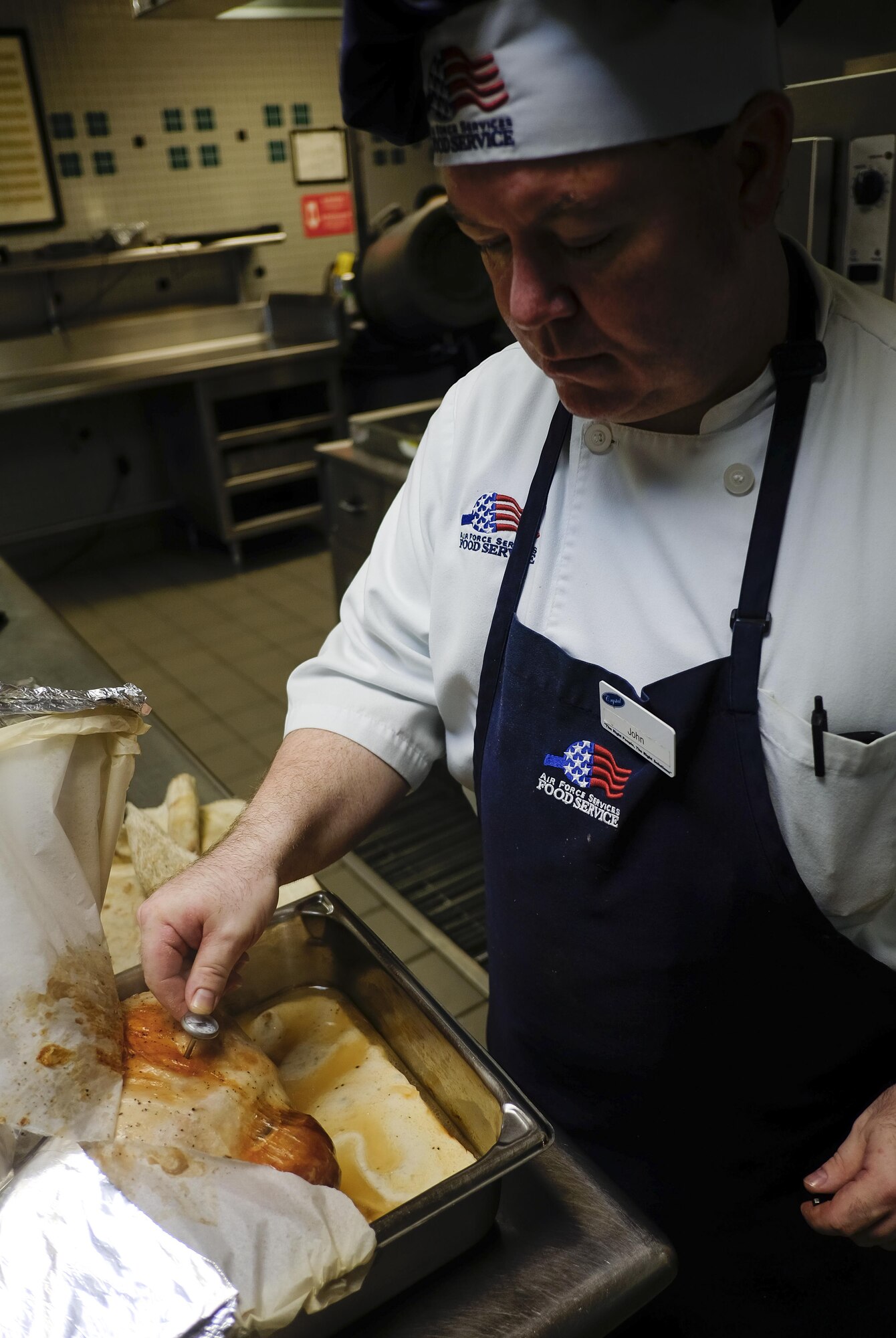 John Collins, a contract cook with the 1st Special Operations Force Support Squadron, inspects a turkey in preparation for the Reef dining facility’s Thanksgiving luncheon at Hurlburt Field, Fla., Nov. 25, 2015. Airmen with the 1st SOFSS have been preparing for the upcoming Thanksgiving lunch buffet for more than two months. (U.S. Air Force photo by Airman Kai White)
