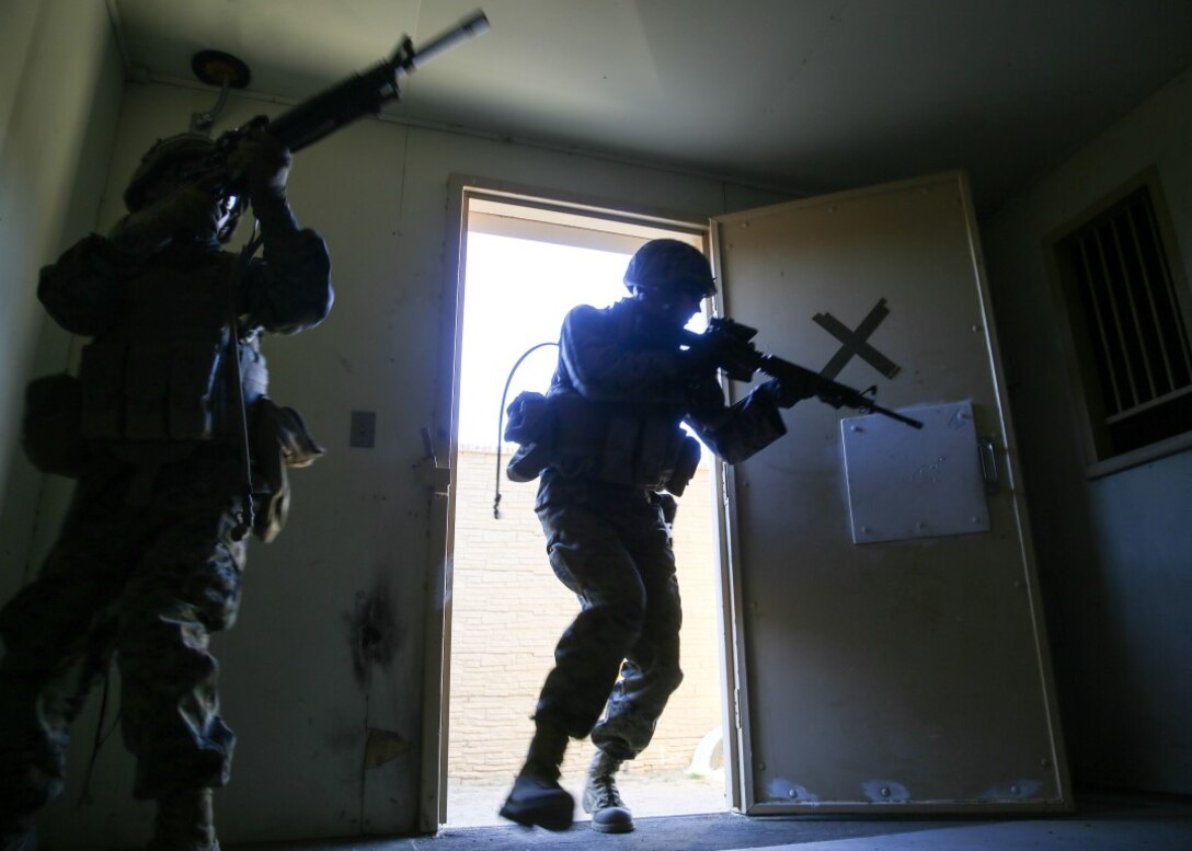 Marines with Combat Logistics Battalion 11 conduct a house raid during a certification exercise of the Basic Combat Skills Course aboard Marine Corps Base Camp Pendleton, Calif., Nov. 20, 2015. BCSC serves as a refamiliarization course for non-infantry Marines, teaching the fundamental skills needed to operate in a combat zone. (U.S. Marine Corps photo by Lance Cpl. Devan K. Gowans/Released)