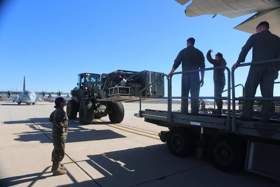 Marines of 3rd Marine Aircraft Wing guide a forklift holding Tactical Imagery Production System components onto a KC-130J Super Hercules during a loading exercise aboard Marine Corps Air Station Miramar, Calif., Nov. 20. A TIPS is a highly mobile, rapidly deployable, self-contained tactical shelter system with imagery and reproduction capabilities that can be used while deployed in austere conditions.