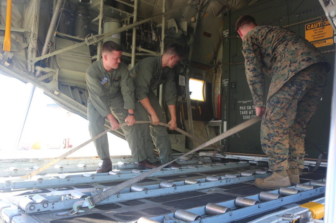 Marines of 3rd Marine Aircraft Wing proceed to remove the Tactical Imagery Production System from the KC-130J Super Hercules during a loading exercise aboard Marine Corps Air Station Miramar, Calif., Nov. 20. A TIPS is a highly-mobile, rapidly-deployable, self-contained tactical shelter system with imagery and reproduction capabilities that can be used while deployed in austere conditions.