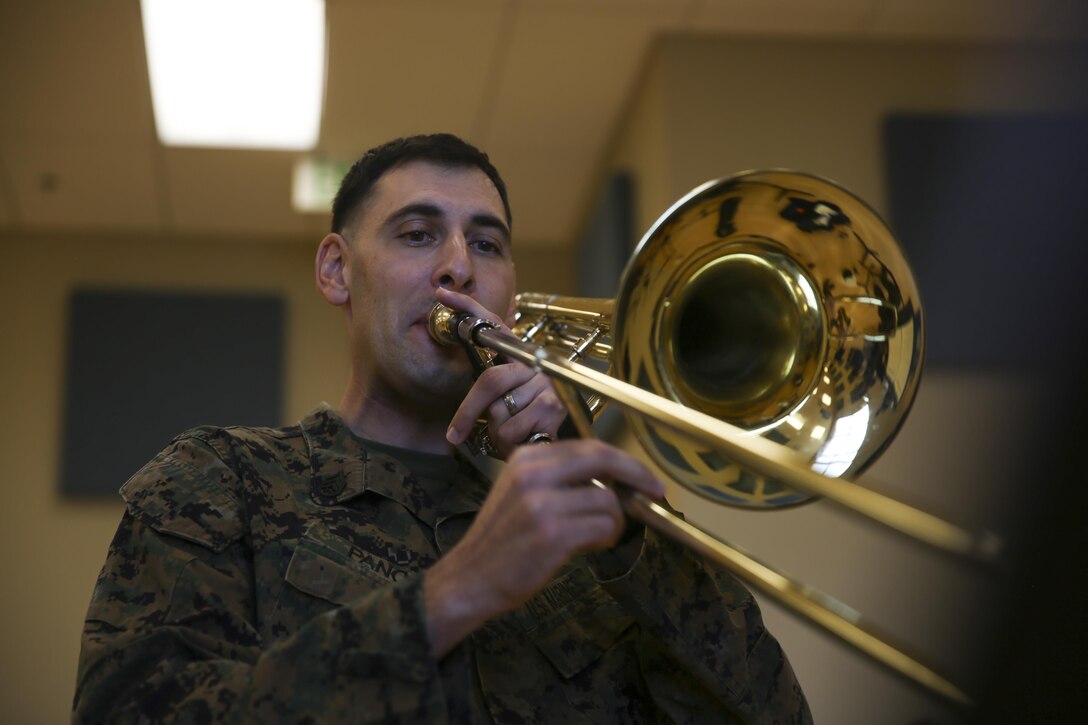 Staff Sgt. Alexander Panos, a trombone player with the 1st Marine Division Band, rehearses alongside his fellow Marines aboard Marine Corps Base Camp Pendleton, Nov. 23, 2015. Panos was recognized as the Marine Corps Musician of the Year Award for 2015. (U.S. Marine Corps photo by Cpl. Will Perkins/ RELEASED)
