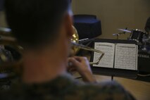 Staff Sgt. Alexander Panos, a trombone player with the 1st Marine Division Band, rehearses alongside his fellow Marines aboard Marine Corps Base Camp Pendleton, Nov. 23, 2015. Panos was recognized as the Marine Corps Musician of the Year Award for 2015. (U.S. Marine Corps photo by Cpl. Will Perkins/ RELEASED)