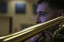 Staff Sgt. Alexander Panos, a trombone player with the 1st Marine Division Band, rehearses alongside his fellow Marines aboard Marine Corps Base Camp Pendleton, Nov. 23, 2015. Panos was recognized as the Marine Corps Musician of the Year Award for 2015. (U.S. Marine Corps photo by Cpl. Will Perkins/ RELEASED)