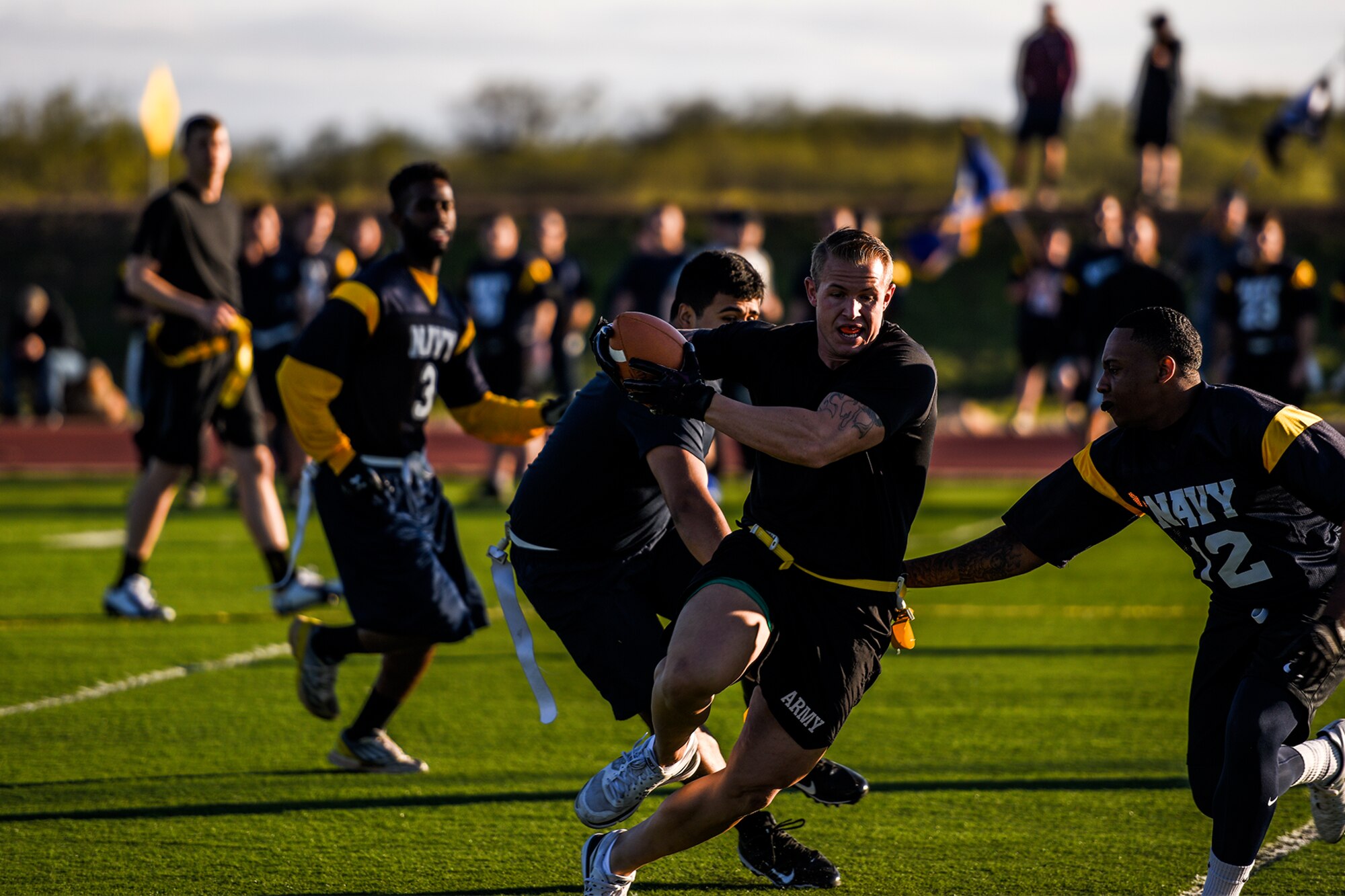 U.S. Army Cpl. Shaun Lubow, 344th Military Intelligence Battalion student, runs a football down a field during the annual Army and Navy football game on Goodfellow Air Force Base, Texas, Nov. 24, 2015. (U.S. Air Force Photo by Airman 1st Class Devin Boyer/Released)