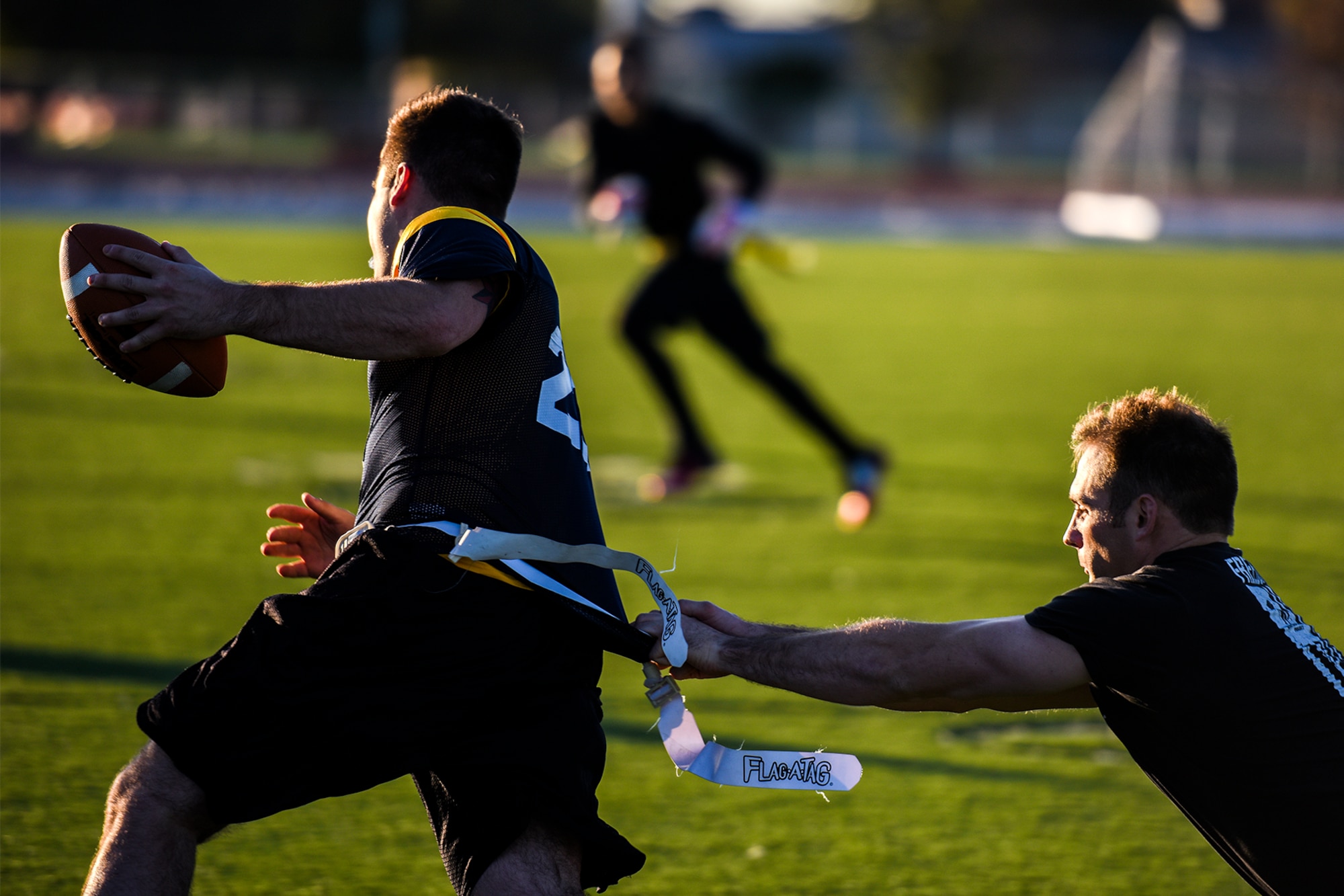 U.S. Army Spc. James Awerkamp, 344th Military Intelligence Battalion student, grabs the flag of U.S. Navy Petty Officer 2nd Class Daniel Gagnon, Navy Center for Information Dominance Detachment student, during the annual Army and Navy football game on Goodfellow Air Force Base, Texas, Nov. 24, 2015. (U.S. Air Force Photo by Airman 1st Class Devin Boyer/Released)