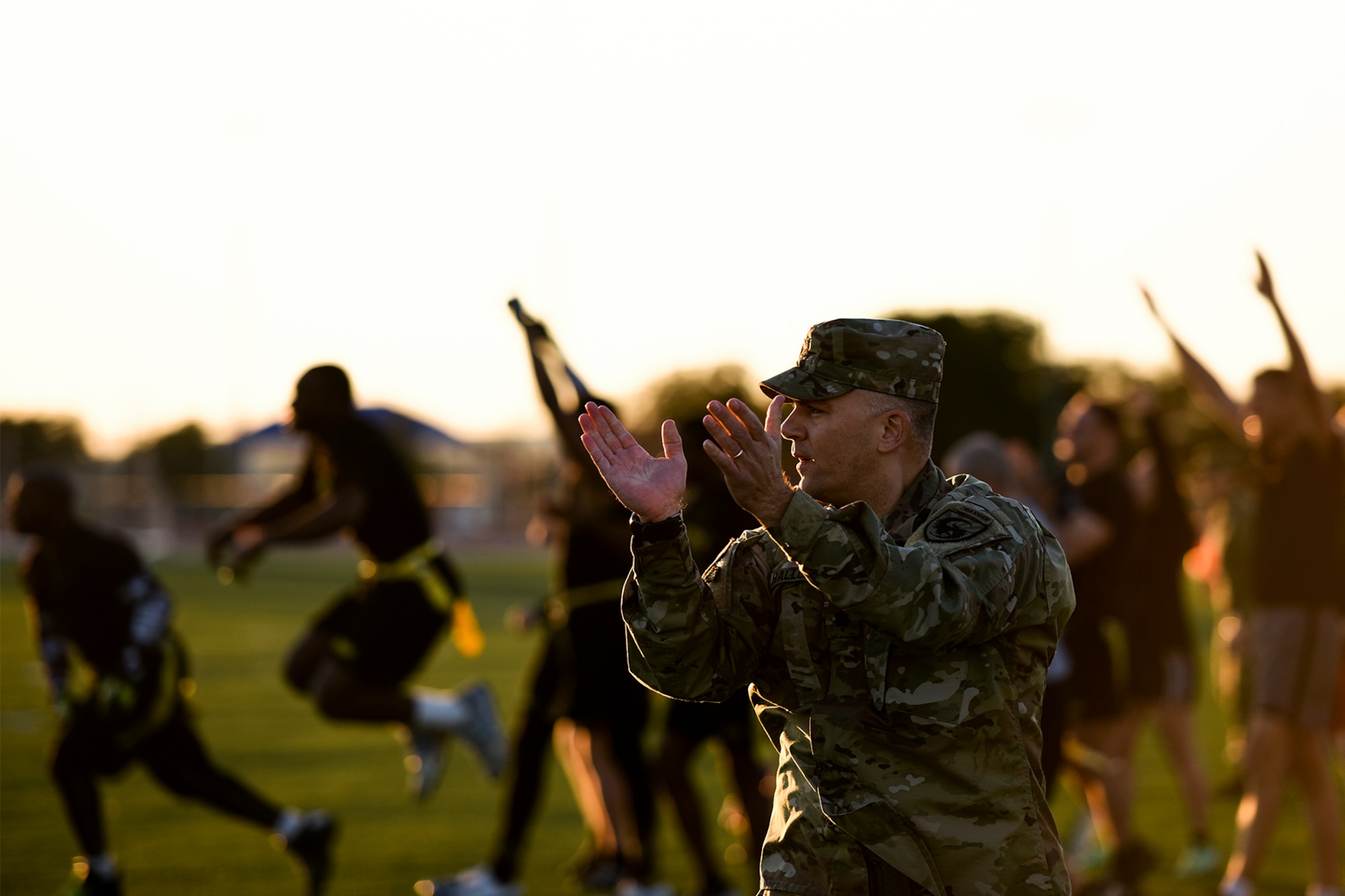 U.S. Army Lt. Col. Jason D. Hallock, 344th Military Intelligence Battalion Commander, applauds after his team scores a touchdown during the annual Army and Navy football game on Goodfellow Air Force Base, Texas, Nov. 24, 2015. (U.S. Air Force Photo by Airman 1st Class Devin Boyer/Released)