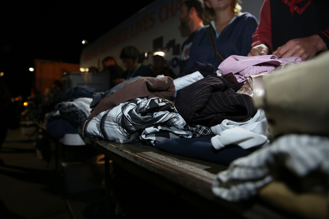 The Dream Center puts donated clothing in a line to be handed out to homeless people during  Adopt-A-Block in San Diego, Nov. 21. The Dream Center is a faith-based organization that focuses their efforts on homeless outreach.(U.S. Marine Corps photo by Cpl. Alissa P. Schuning)