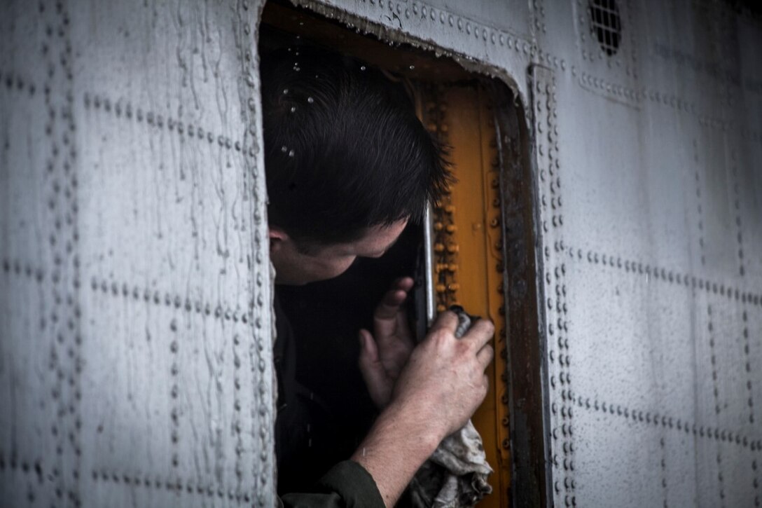 PACIFIC OCEAN (Nov. 23, 2015)  A U.S. Marine with Marine Medium Tiltrotor Squadron 161 (Reinforced), 15th Marine Expeditionary Unit, scrubs grime off an aircraft on the flight deck of the USS Essex (LHD 2). The 15th MEU is currently deployed in the Indo-Asia-Pacific region to promote regional stability and security in the U.S. 7th Fleet area of operations. (U.S. Marine Corps photo by Cpl. Elize McKelvey/Released)
