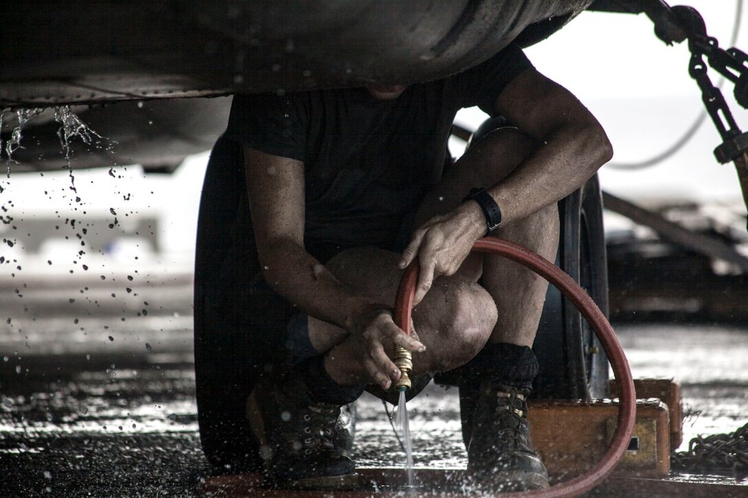 PACIFIC OCEAN (Nov. 23, 2015)  A U.S. Marine with Marine Medium Tiltrotor Squadron 161 (Reinforced), 15th Marine Expeditionary Unit, washes an aircraft on the flight deck of the USS Essex (LHD 2). The 15th MEU is currently deployed in the Indo-Asia-Pacific region to promote regional stability and security in the U.S. 7th Fleet area of operations. (U.S. Marine Corps photo by Cpl. Elize McKelvey/Released)