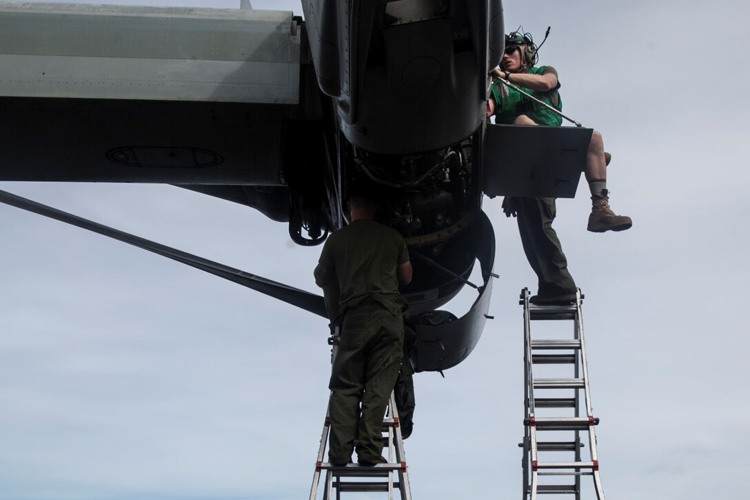 PACIFIC OCEAN (Nov. 23, 2015)  U.S. Marines with Marine Medium Tiltrotor Squadron 161 (Reinforced), 15th Marine Expeditionary Unit, fix equipment on the wing of an MV-22B Osprey on the flight deck of the USS Essex (LHD 2). The 15th MEU is currently deployed in the Indo-Asia-Pacific region to promote regional stability and security in the U.S. 7th Fleet area of operations. (U.S. Marine Corps photo by Cpl. Elize McKelvey/Released)