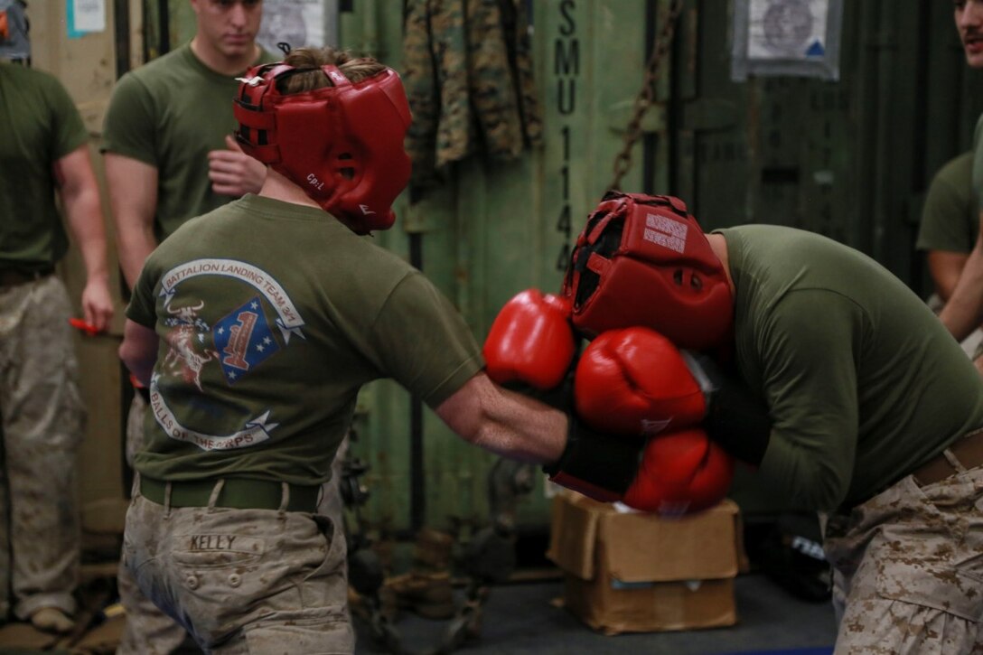PHILIPPINE SEA (Nov. 23, 2015) U.S. Marine Lance Cpl. Mike Kelly, left, spars with Staff Sgt. Angel Quinones aboard the USS Anchorage (LPD 23). Kelly is a tank driver with 1st Tanks Detachment, Battalion Landing Team 3rd Battalion, 1st Marine Regiment, 15th Marine Expeditionary Unit, and Quinones is the mess chief for Battalion Landing Team 3/1, 15th MEU. The 15th MEU is currently deployed in the Indo-Asia-Pacific region to promote regional stability and security in the U.S. 7th Fleet area of operations. (U.S. Marine Corps photo by Sgt. Steve H. Lopez/Released)