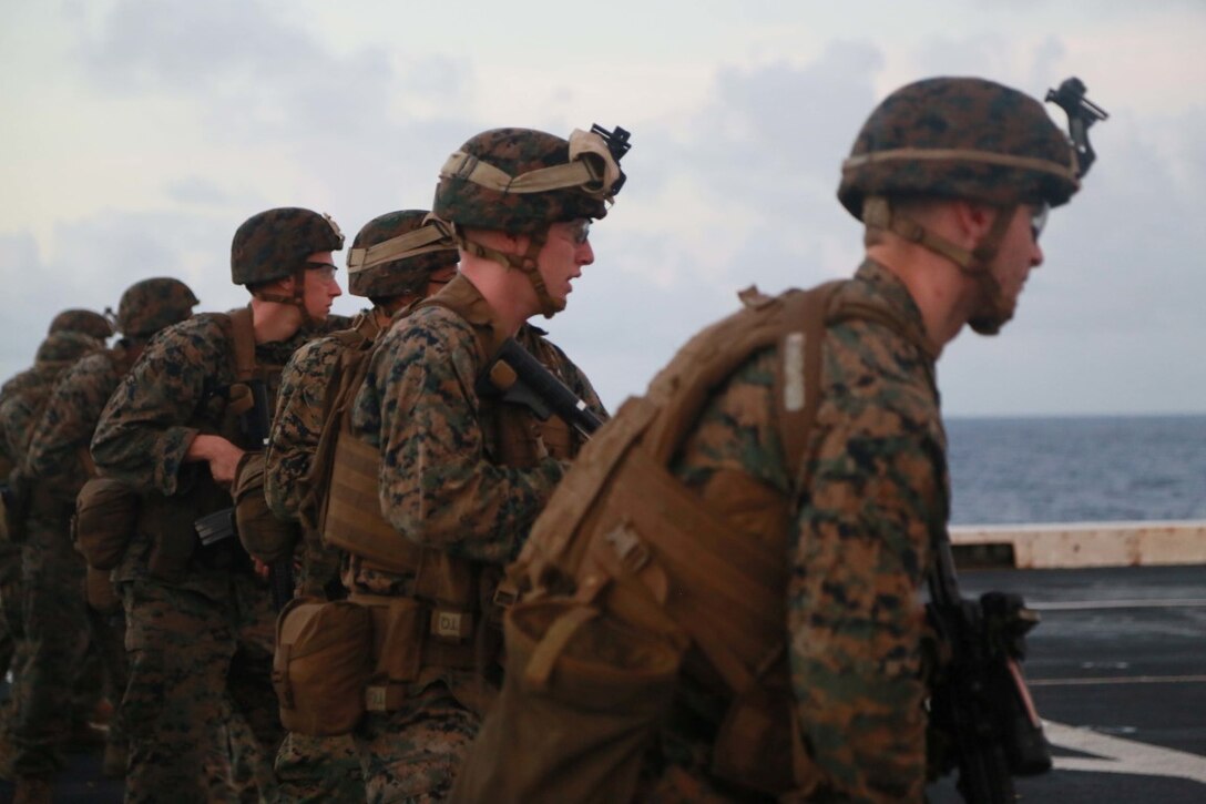 PHILIPPINE SEA (Nov. 24, 2015) U.S. Marines with 1st Light Armored Reconnaissance Detachment, Battalion Landing Team 3rd Battalion, 1st Marine Regiment, 15th Marine Expeditionary Unit, prepare to fire their weapons on the flight deck aboard the USS Anchorage (LPD 23). The 15th MEU is currently deployed in the Indo-Asia-Pacific region to promote regional stability and security in the U.S. 7th Fleet area of operations. (U.S. Marine Corps photo by Sgt. Steve H. Lopez/Released)