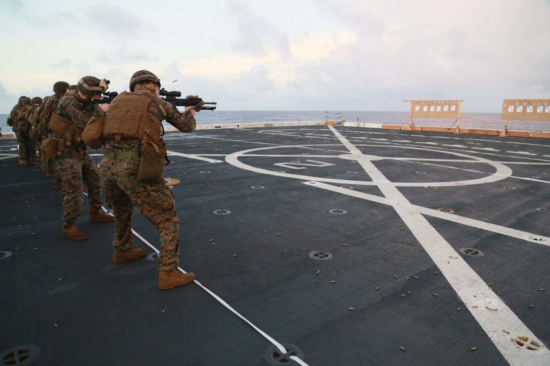 PHILIPPINE SEA (Nov. 24, 2015) U.S. Marines with 1st Light Armored Reconnaissance Detachment, Battalion Landing Team 3rd Battalion, 1st Marine Regiment, 15th Marine Expeditionary Unit, fire their weapons on the flight deck aboard the USS Anchorage (LPD 23). The 15th MEU is currently deployed in the Indo-Asia-Pacific region to promote regional stability and security in the U.S. 7th Fleet area of operations. (U.S. Marine Corps photo by Sgt. Steve H. Lopez/Released)