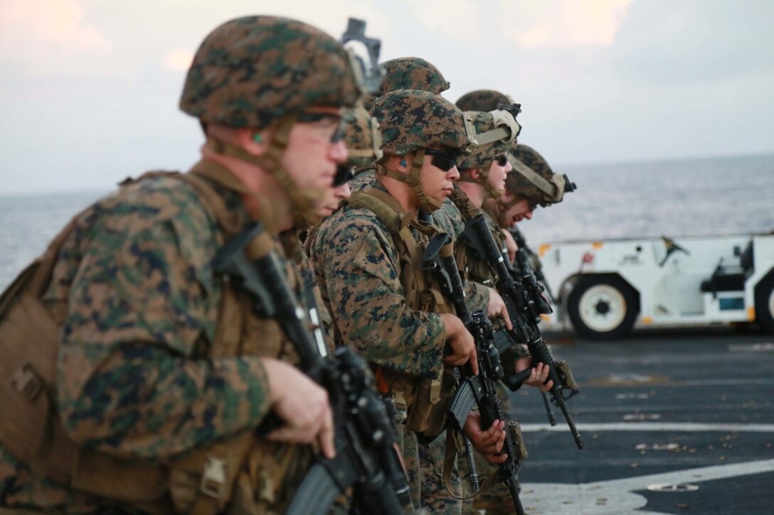 PHILIPPINE SEA (Nov. 24, 2015) U.S. Marines with 1st Light Armored Reconnaissance Detachment, Battalion Landing Team 3rd Battalion, 1st Marine Regiment, 15th Marine Expeditionary Unit, prepare to fire their weapons on the flight deck aboard the USS Anchorage (LPD 23). The 15th MEU is currently deployed in the Indo-Asia-Pacific region to promote regional stability and security in the U.S. 7th Fleet area of operations. (U.S. Marine Corps photo by Sgt. Steve H. Lopez/Released)