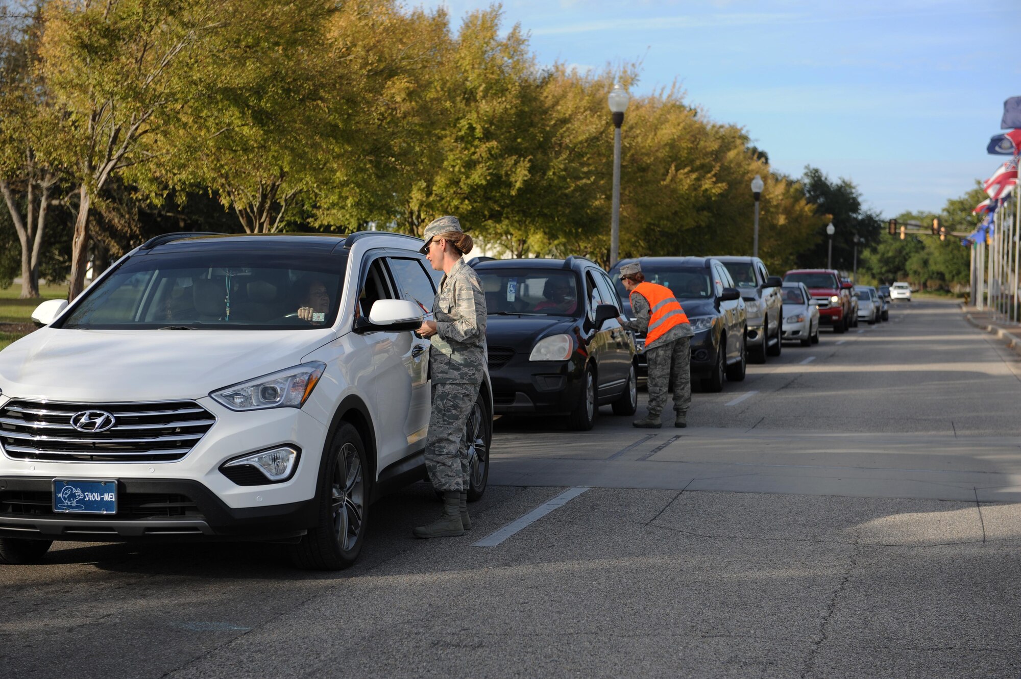 Col. Michele Edmondson, 81st Training Wing commander, delivers a holiday safety message to Keesler personnel as they depart the White Avenue gate Nov. 24, 2015, Keesler Air Force Base, Miss. Keesler leadership also passed out Airmen Against Drunk Driving cards to base personnel at all of the gates and reminded Airmen to ensure they stay safe this holiday weekend. (U.S. Air Force photo by Kemberly Groue)
