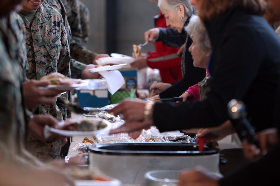 Members of the Havelock Military Affairs Committee and Chamber of Commerce serve a Thanksgiving lunch to the Marines and Sailors of Marine Transport Squadron 1 at Marine Corps Air Station Cherry Point, N.C., Nov. 25, 2015. This is the fourth year that the Havelock community has come to the air station to offer the squadron a Thanksgiving meal as a way to show their thanks for all that the Marines do. (U.S. Marine Corps photo by Pfc. Nicholas P. Baird/ Released)