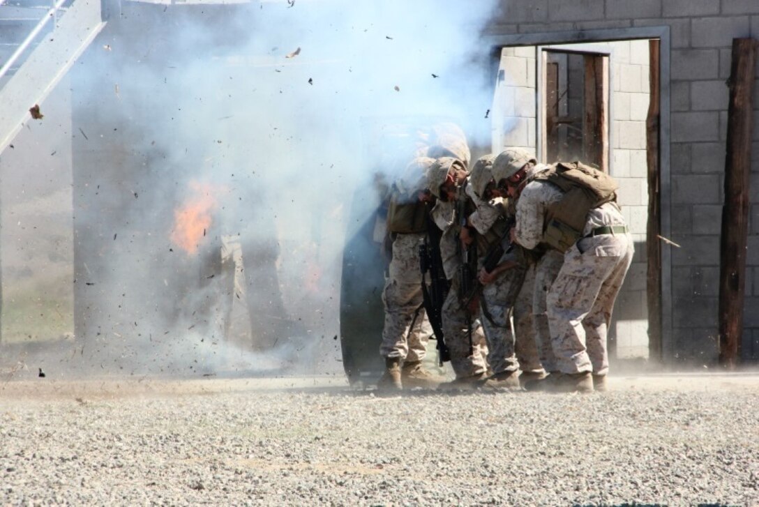 Lance Cpl. Taylor Drake, a combat engineer with 1st Combat Engineer Battalion, 1st Marine Division, breaches a door with an oval charge aboard Marine Corps Base Camp Pendleton, Calif. Drake, a Phoenix native, conducted breaching and room clearing drills with 2nd Platoon, Bravo Company, 1st CEB Marines, Oct. 8, 2015.