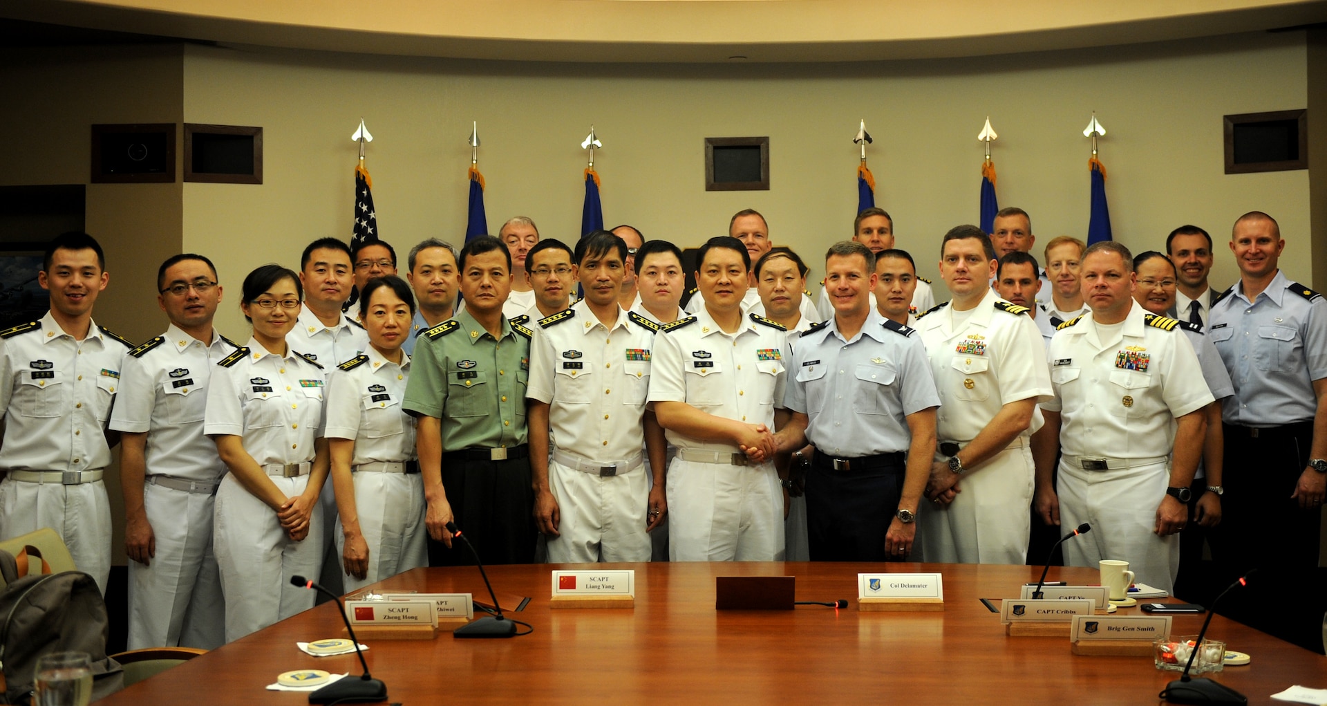 JOINT BASE PEARL HARBOR-HICKAM, Hawaii (Nov. 25, 2015) - Representatives from the U.S. and PRC militaries pose for a group photo prior to the start of the bi-annual Military Maritime Consultative Agreement (MMCA) talks, held Nov. 21-24, at Headquarters, Pacific Air Forces, Joint Base Pearl Harbor-Hickam, Hawaii. The bilateral MMCA talks are a long-standing mechanism designed to provide open and transparent communication to address concerns and develop common understanding between U.S. and PRC air and naval forces in order to avoid unsafe incidents and minimize risk.