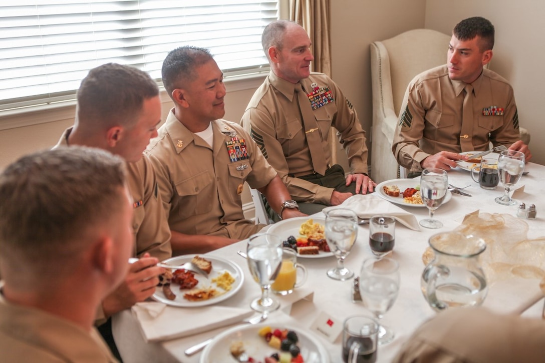 Master Chief Petty Officer Harlan Patawaran, the command master chief of 1st Marine Logistics Group, I Marine Expeditionary Force, and Sgt. Maj. Troy Black, the 1st MLG sergeant major, speak to junior enlisted service members at an awards breakfast aboard Marine Corps Base Camp Pendleton, Calif., Nov. 20, 2015. The breakfast was held at the house of Brig. Gen. David Ottignon’s, commanding general of 1st MLG, and honored the dedication shown by the service members who were present.