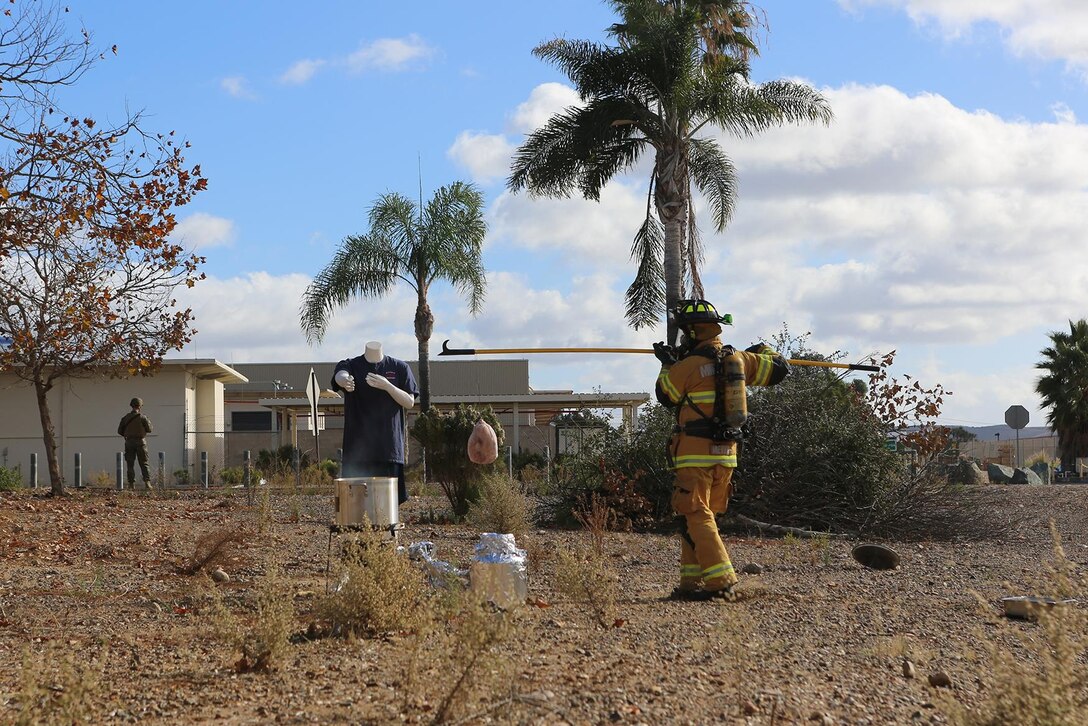 A firefighter with the Miramar Fire Department begins to lower a turkey into a fryer during a demonstration of the improper use of a turkey fryer aboard Marine Corps Air Station Miramar, Calif., Nov 21. The Miramar Fire Department held the annual demonstration for Marines with Headquarters Squadron, Marine Aircraft Group 11, to discuss holiday season safety issues and show them preventative measures.