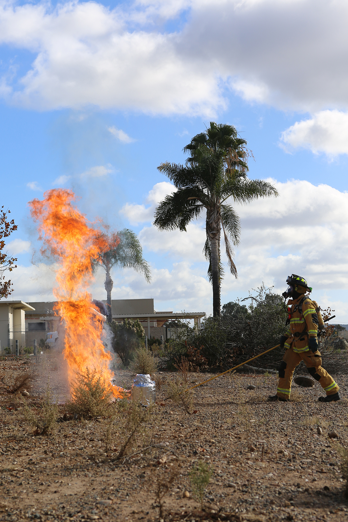 A firefighter with the Miramar Fire Department demonstrates improper use of a turkey fryer aboard Marine Corps Air Station Miramar, Calif., Nov 21. The Miramar Fire Department held the annual demonstration for Marines with Headquarters Squadron, Marine Aircraft Group 11, to discuss holiday season safety issues and show them preventative measures.