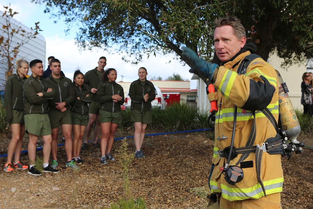A firefighter with the Miramar Fire Department wishes Marines a safe holiday following a demonstration of the improper use of a turkey fryer aboard Marine Corps Air Station Miramar, Calif., Nov 21. The Miramar Fire Department held the annual demonstration for Marines with Headquarters Squadron, Marine Aircraft Group 11, to discuss holiday season safety issues and show them preventative measures.