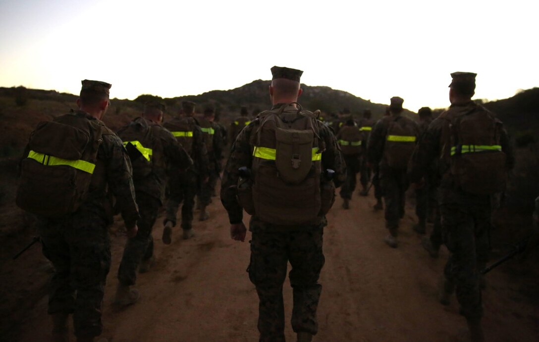 Marines start their nine-mile trek through the Juliet Training Area before the sun crests over the hilltops aboard Marine Corps Base Camp Pendleton, Calif., Nov. 20, 2015. The unit hike brought Marines together to boost morale, maintain physical fitness and collect canned goods for local charities.  The canned goods collected will be donated to the Women’s Resource Center and Brother Benno’s, organizations in Oceanside, Calif. The organizations’ mission is to help those less fortunate in the community. The Marines are with 7th ESB, 1st Marine Logistics Group, I Marine Expeditionary Force, aboard MCB Camp Pendleton.
(U.S. Marine Corps photo by Lance Cpl. Timothy Valero)