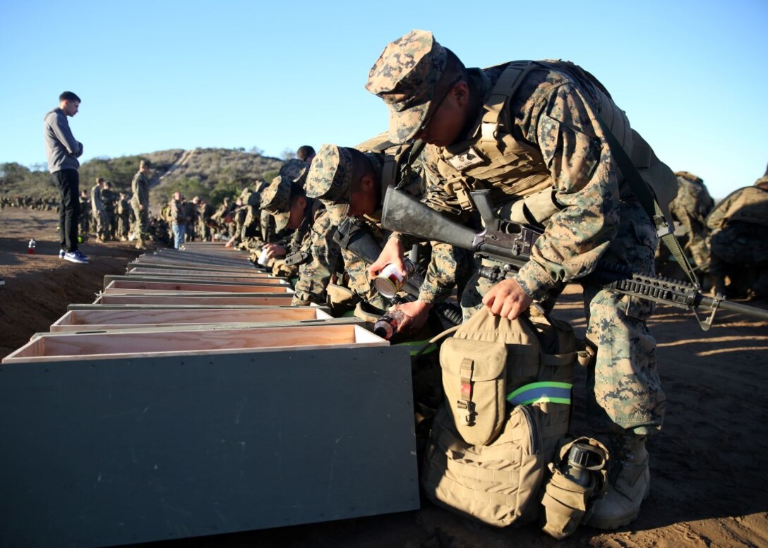 Marines empty canned goods from their packs during a nine-mile hike aboard Marine Corps Base Camp Pendleton, Calif., Nov. 20, 2015. The Marines collected approximately 10,000 pounds of canned goods that will help provide meals for those less fortunate. The canned goods collected will be donated to the Women’s Resource Center and Brother Benno’s, organizations in Oceanside, California. The organizations’ mission is to help those less fortunate in the community.  The Marines are with 7th Engineer Support Battalion, 1st Marine Logistics Groups, I Marine Expeditionary Force, aboard MCB Camp Pendleton. (U.S. Marine Corps photo by Lance Cpl. Timothy Valero)