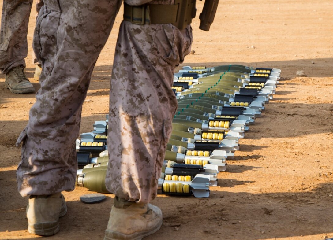 U.S. Marine explosive ordnance disposal (EOD) technicians with 1st EOD, Combat Logistics Battalion 1, Combat Logistics Regiment 1, 1st Marine Logistics Group, stands over unserviceable high explosive (HE) mortars on a demolition range at Al Asad Air Base, Iraq, Nov. 9, 2015. The EOD techs prepare the mortars for a controlled detonation to rid these HE mortars that were deemed unserviceable by an ammo technician. 1st EOD is an element of Special Purpose Marine Air Ground Task Force - Crisis Response - Central Command, in support of Combined Joint Task Force – Operation Inherent Resolve. (U. S. Marine Corps photo by Staff Sgt. Nathan O. Sotelo/Released)