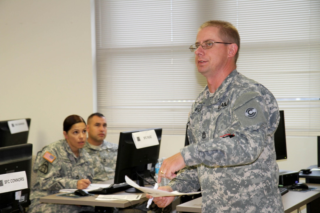 Sgt. 1st Class Marion Fox teaches a block of instruction to his fellow classmates as part of his training for phase 1 of the 94th Training Division's Finance Senior Leaders Course at Fort Dix, New Jersey.     